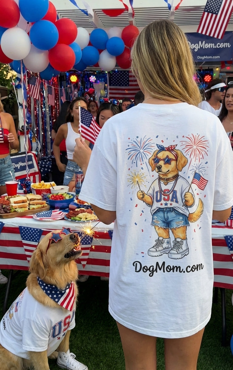 Woman and dog wearing 'DogMom.com' t-shirts at a patriotic event with balloons and flags.