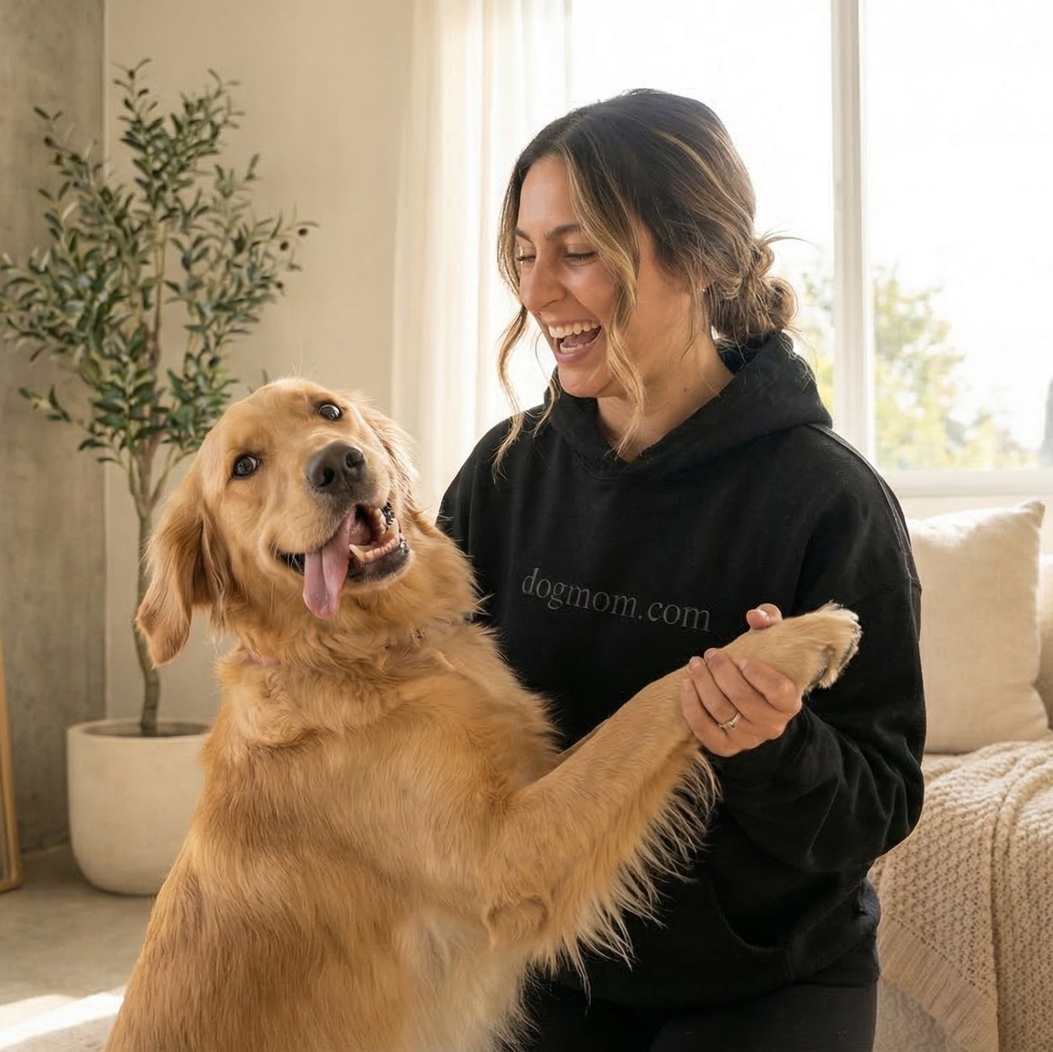 Woman playing with a dog in a cozy living room