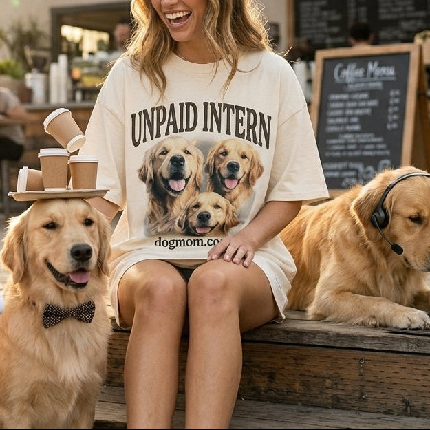 Woman sitting with three dogs in a casual outdoor setting, wearing an 'Unpaid Intern' shirt.