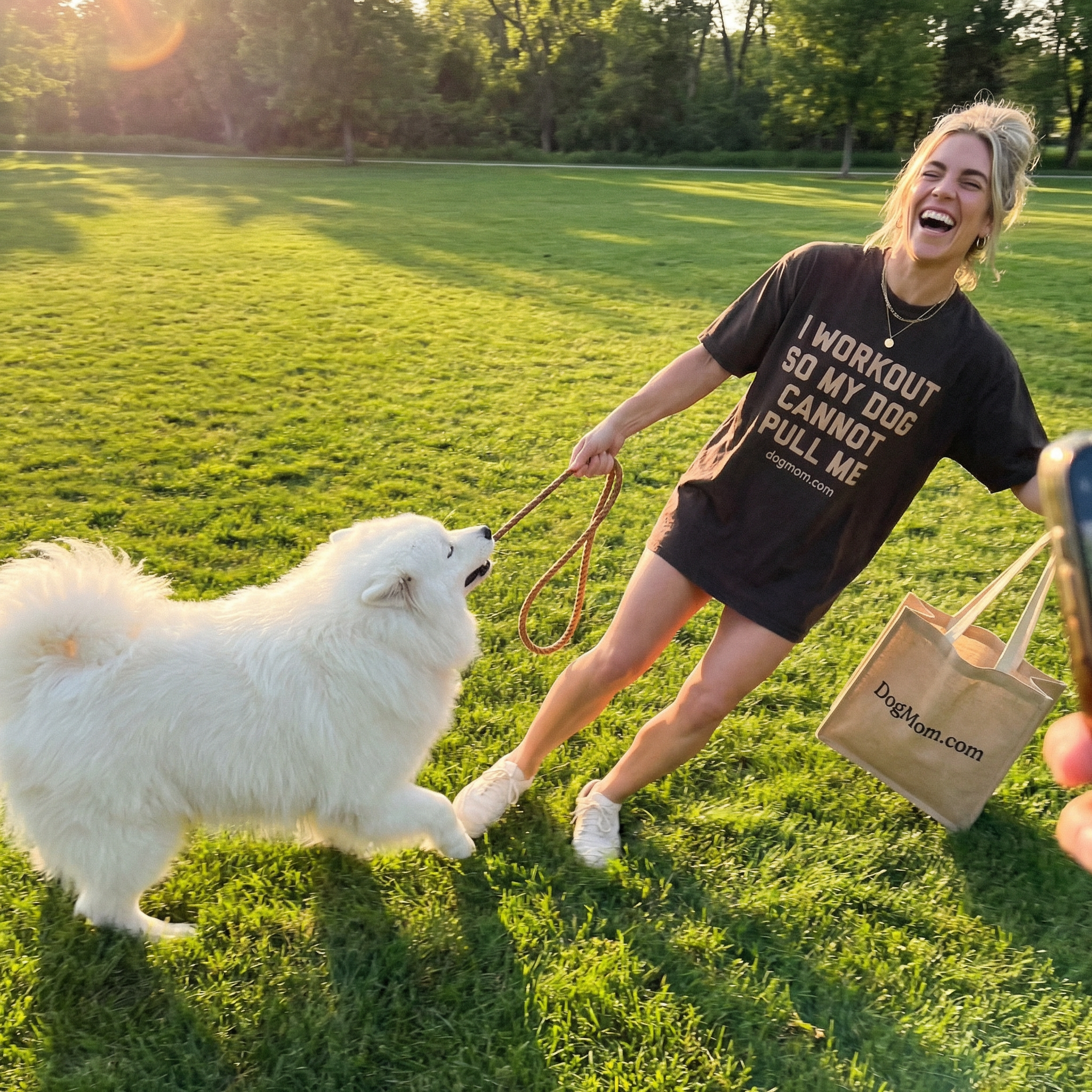 Dog mom being pulled by samoyed at the park wearing I Workout So My Dog Cannot Pull Me tee